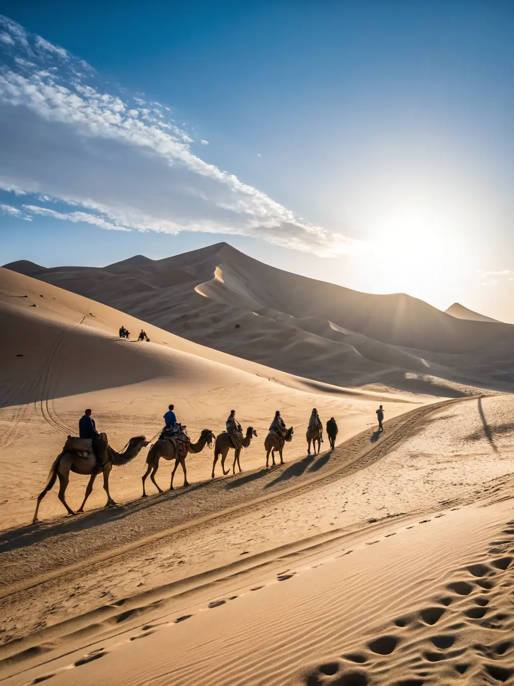 A captivating photograph of a desert safari at sunset, with silhouettes of camels and explorers against the backdrop of a starlit sky, to represent the desert safari exploration type offered by Lizana World Travel.